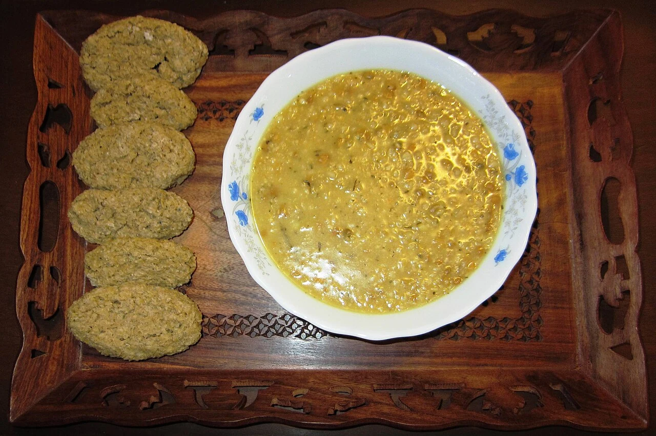 Tarkhineh, dried soup preparations beside a prepared soup.