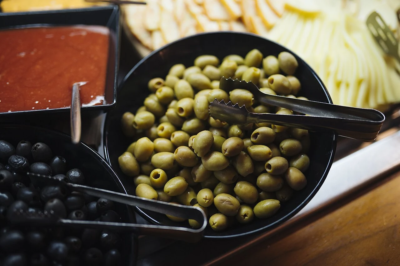 Green and black olives in a modern ingredient photograph.