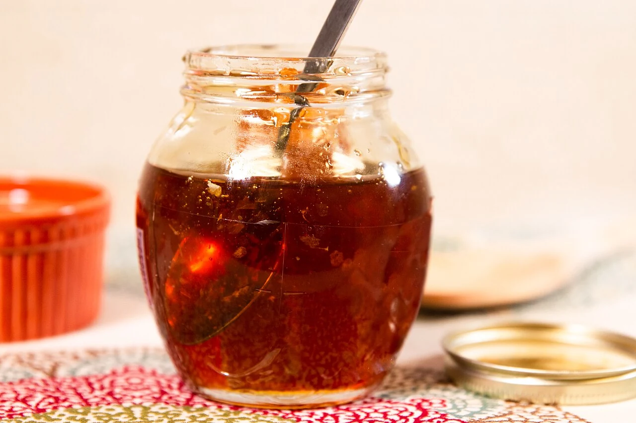 Honey with honeycomb in a modern photograph illustrating a historical sweetener.