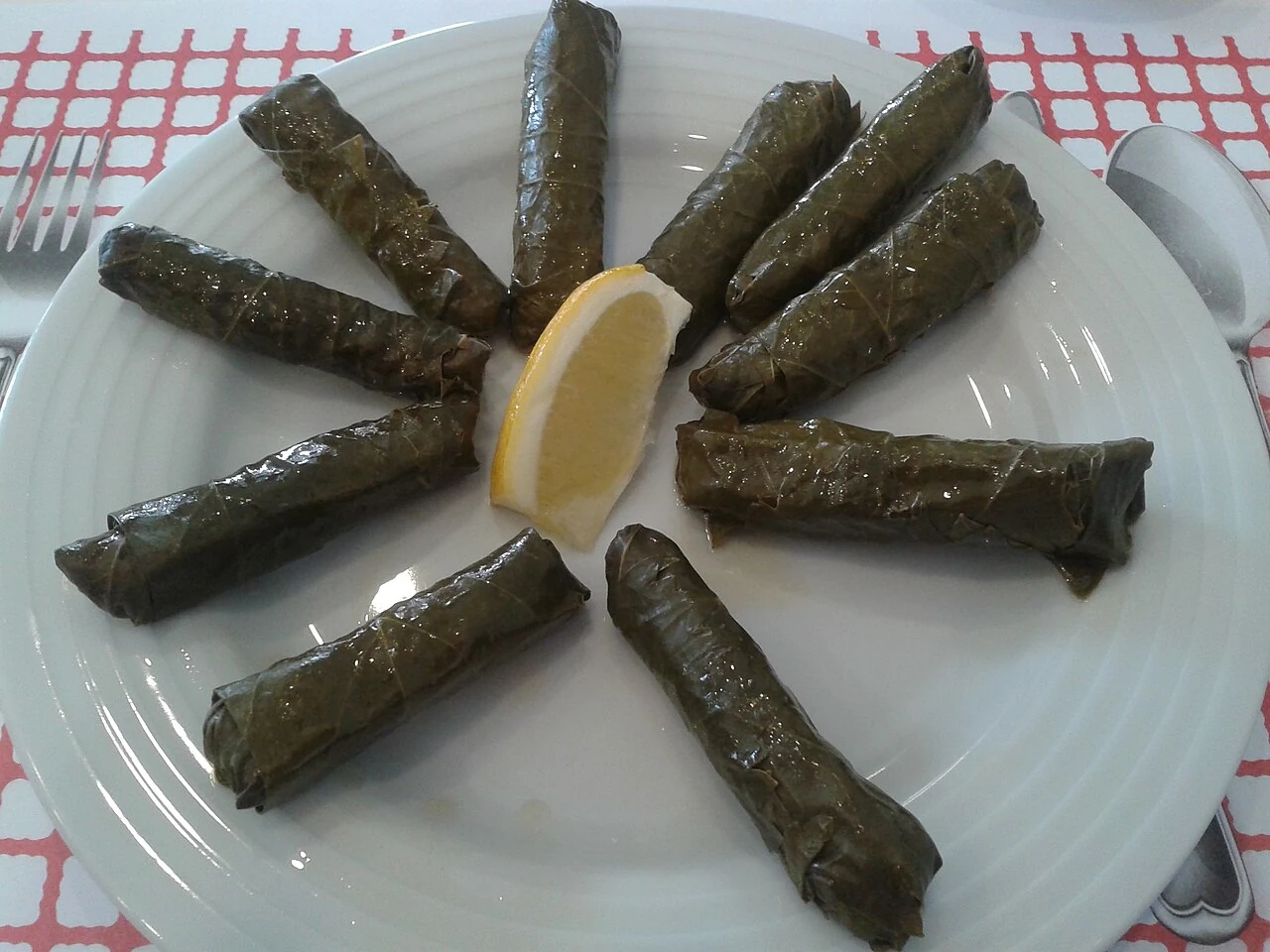 Vine leaves stuffed with rice and served with lemon.