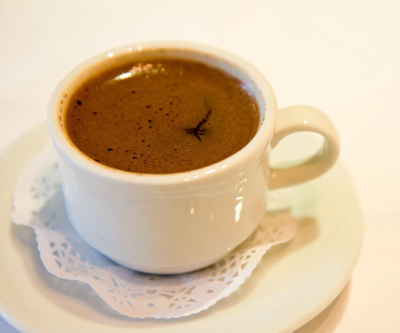Turkish coffee with foam, served in a contemporary cup.