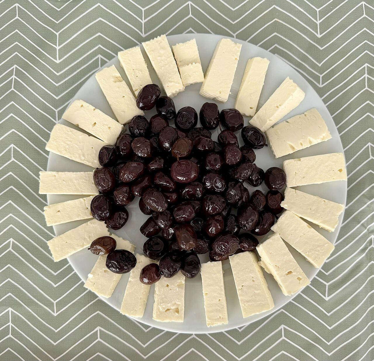 White cheese and olives, breakfast ingredients.