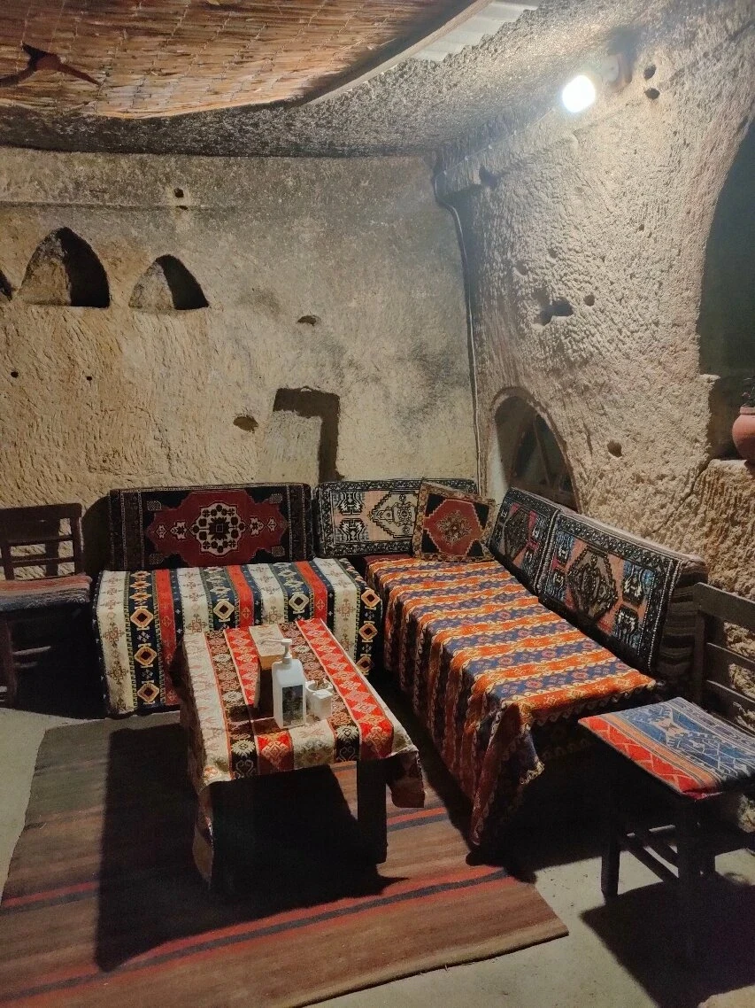 Cave dining area with traditional textiles at Nazar Borek & Cafe, Göreme