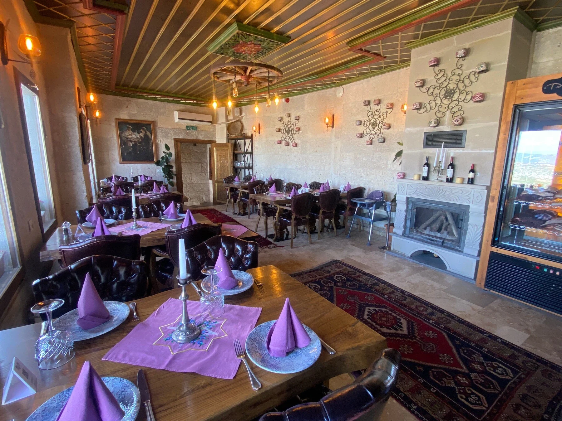 Restaurant dining room with purple table settings at Cappadocia Steak House, Uçhisar