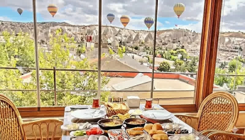 Safran Terrace Restaurant — Terrace breakfast and balloons over Göreme