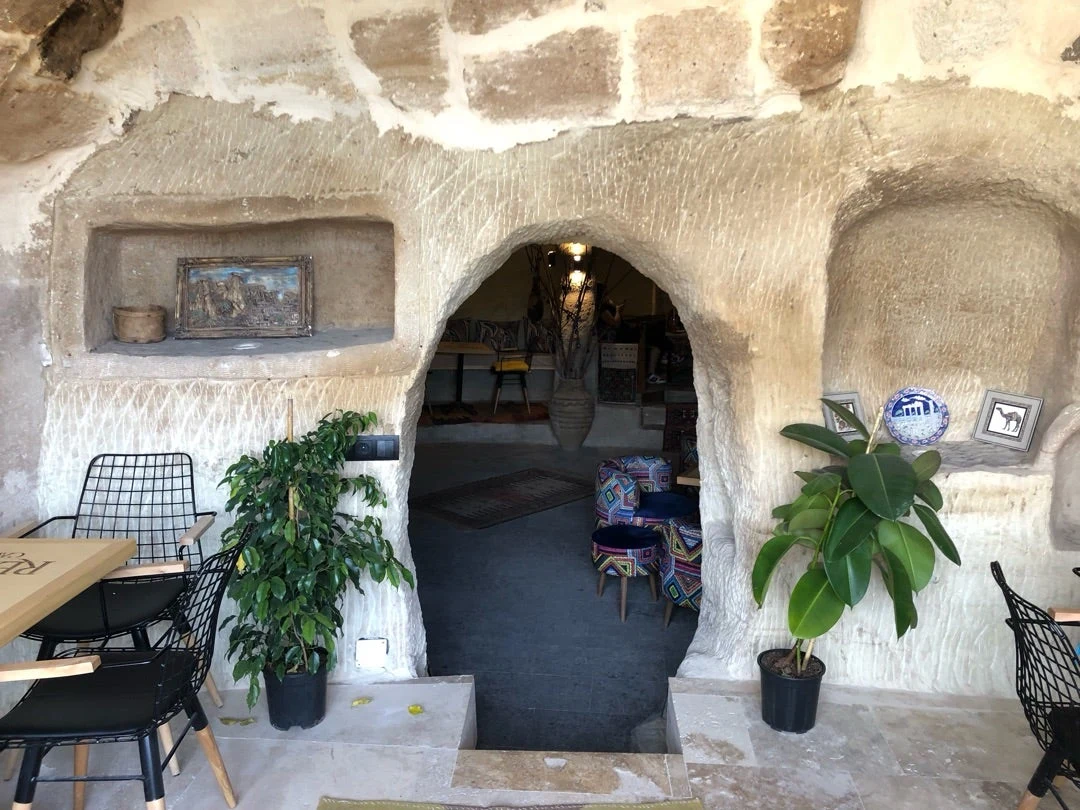 Stone entrance and cave seating at Rebirth Cave Coffee in Mustafapaşa