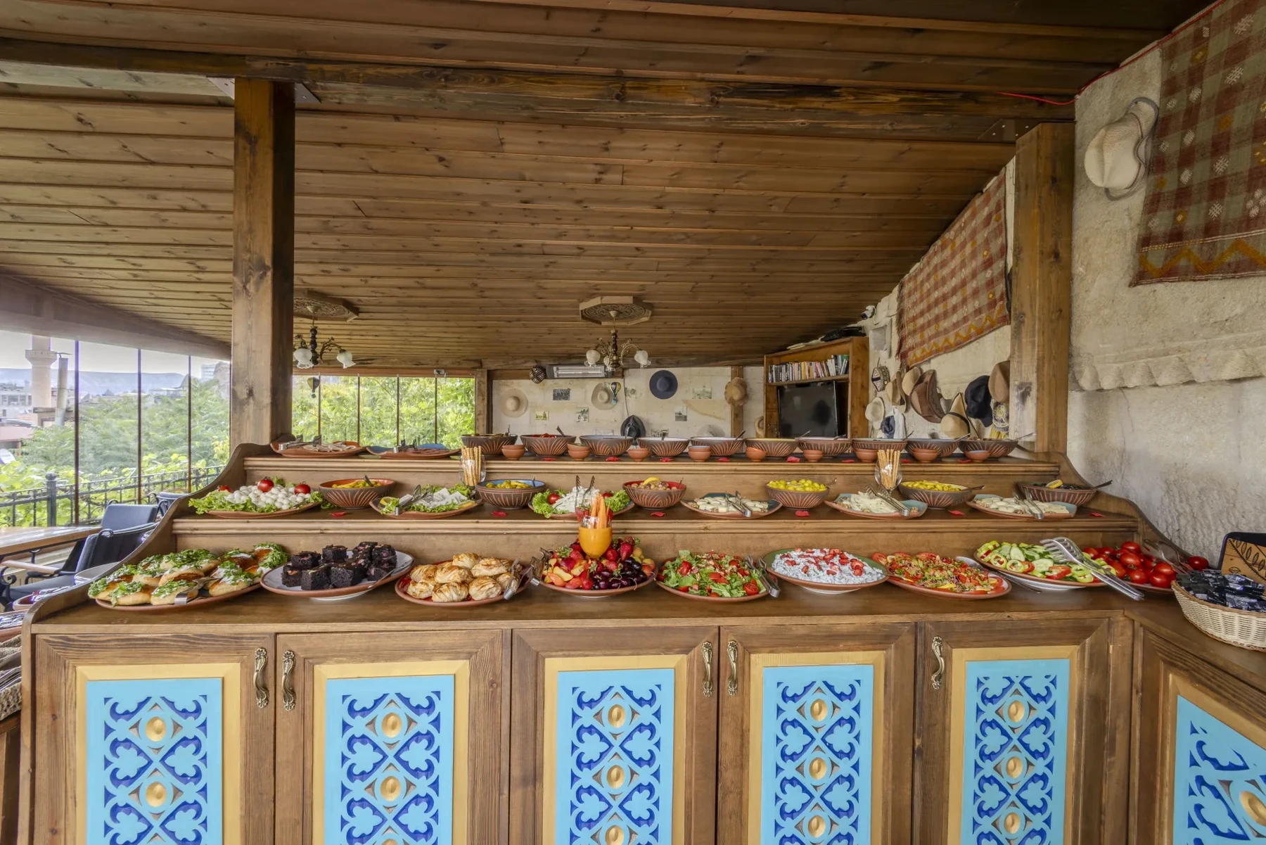 Breakfast buffet and dining-room windows at Hidden Cave Cafe&Hookah, Göreme