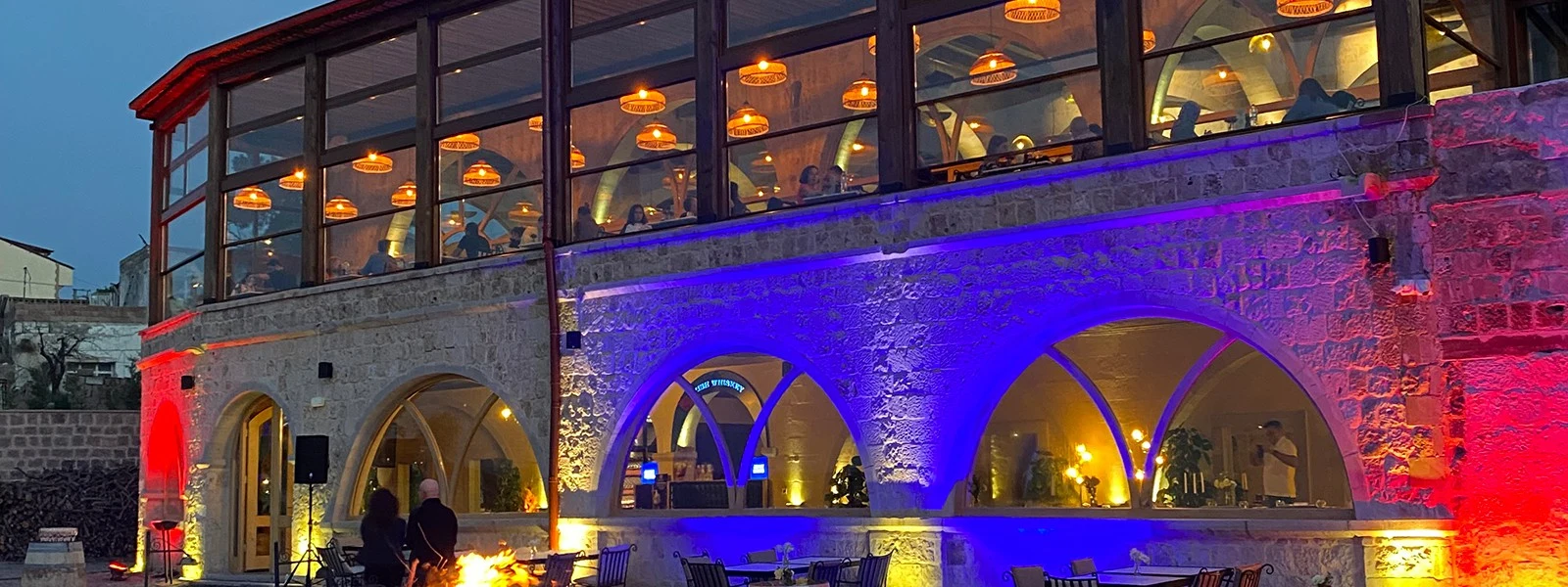 Millocal Restaurant’s stone facade and glazed dining terrace in Uçhisar
