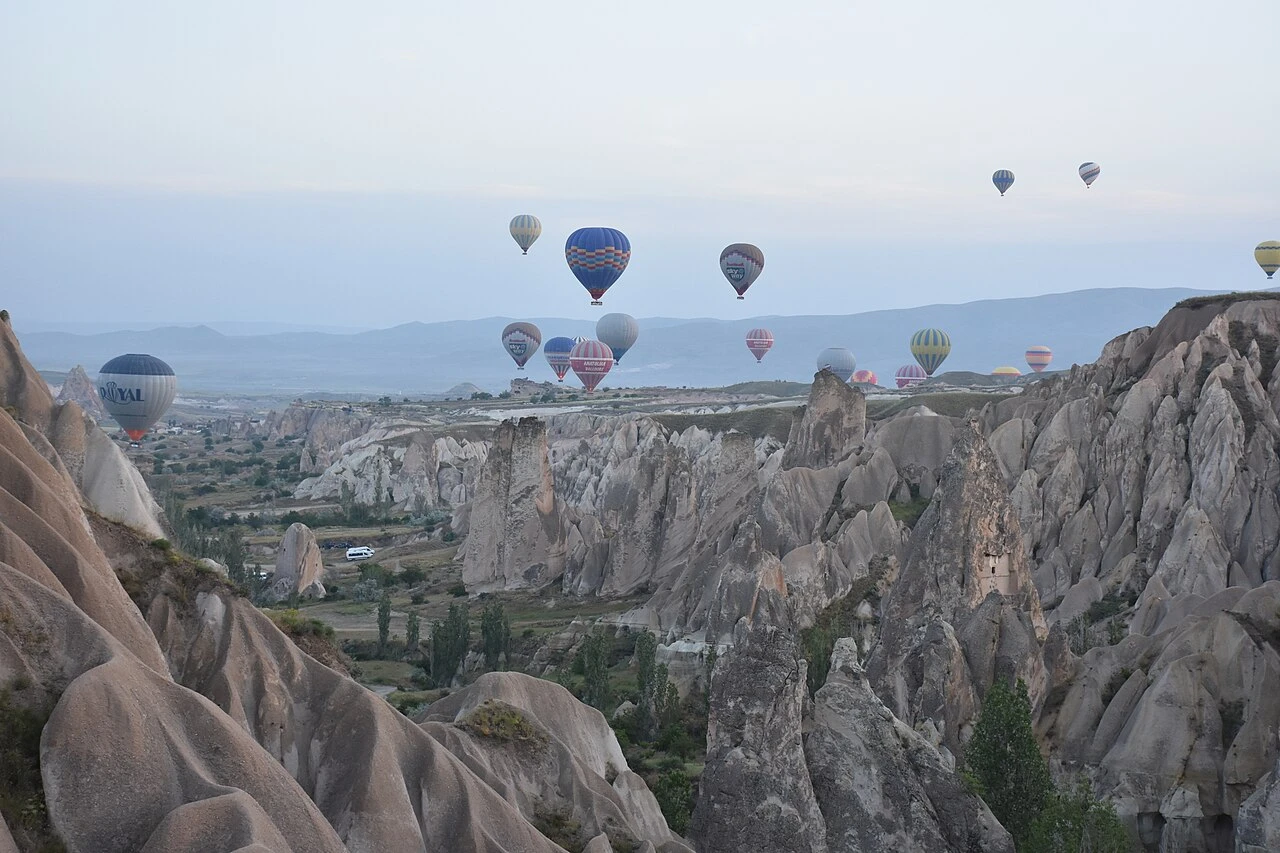 Fairy chimneys and distant balloons near Göreme.