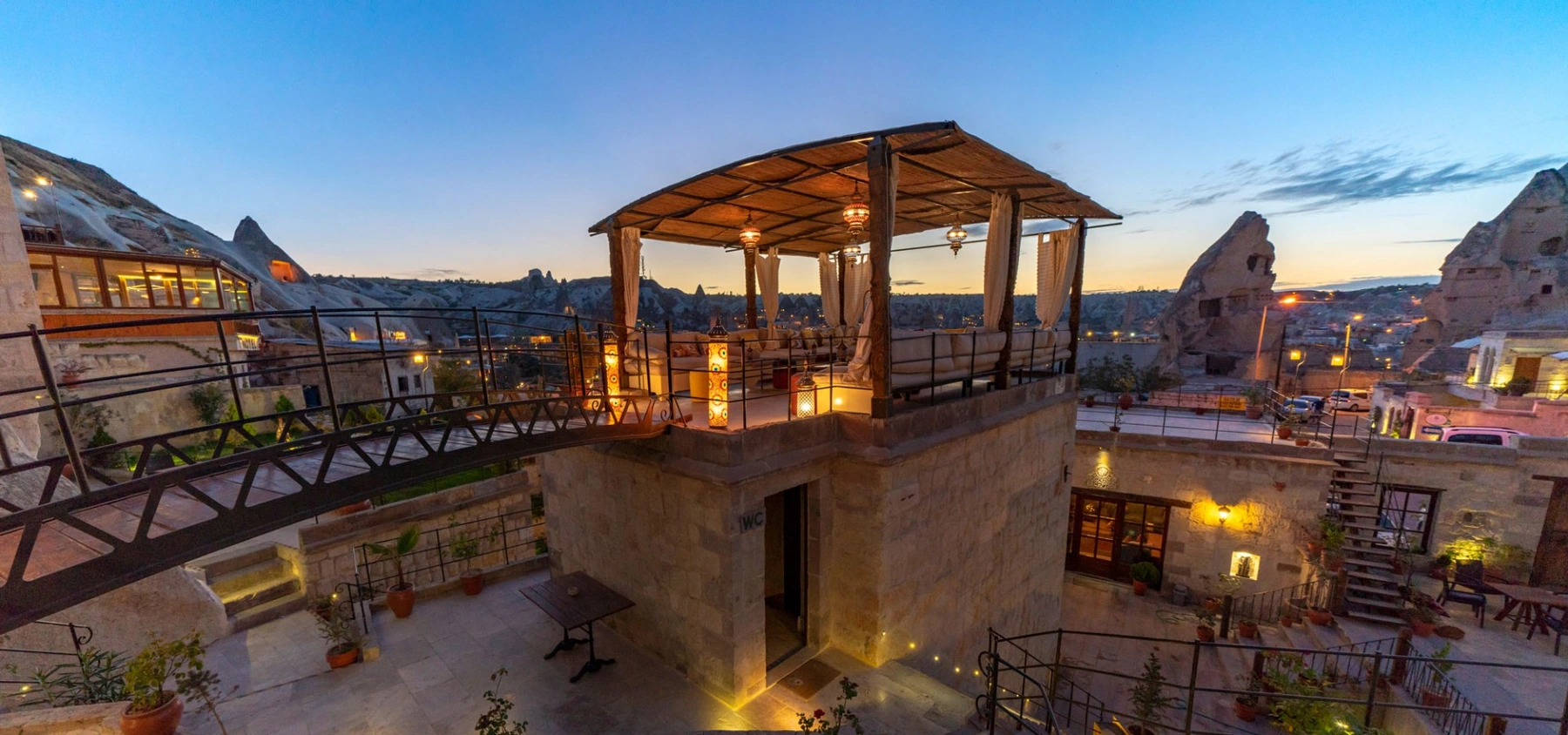 Terrace at Artemis Cave Suites, home of Kaira Rooftop, at dusk